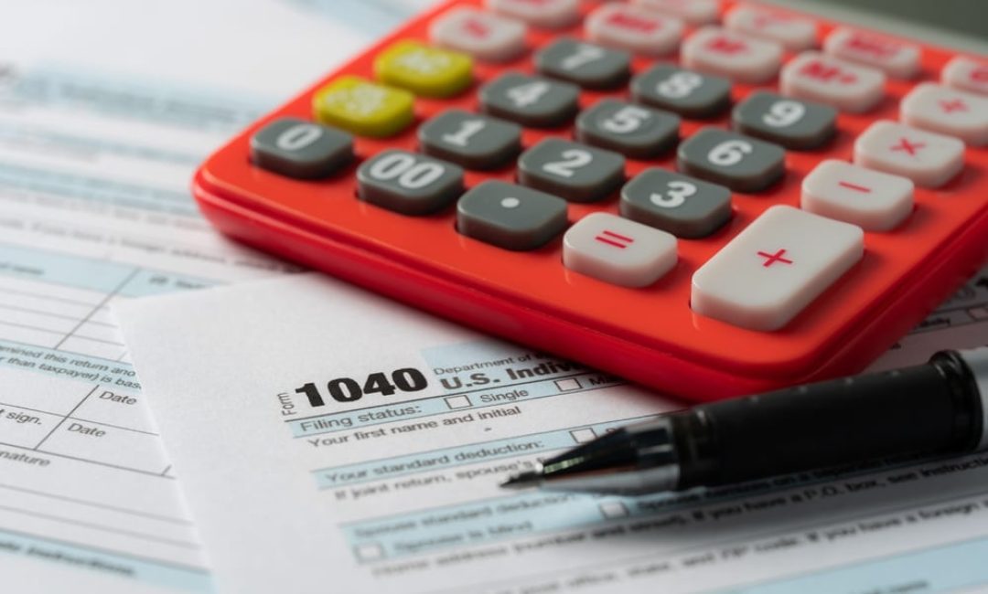 Us,Tax,Form,With,Pen,And,Calculator,Selective,Focus.taxation,Concept